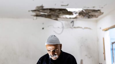 A member of the Druze community in a building that was hit by a rocket fired from Lebanon, in the northern Israeli city of Shefa-Amr. AFP