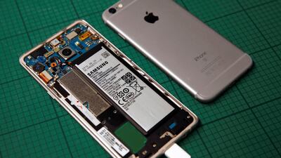 A Samsung Note 7 handset is pictured next to an Apple handset at the battery laboratory in Singapore. Edgar Su / Reuters