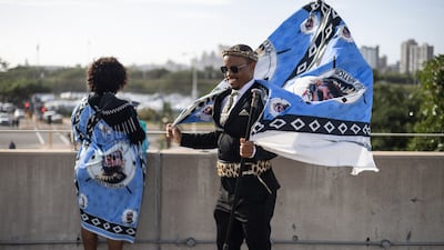 A Zulu woman and a man with traditional colours at the Moses Mabhida Stadium in Durban. AFP