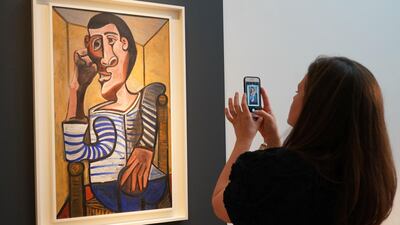 Are we ever really looking at the art, if we're taking a photo of it? AFP