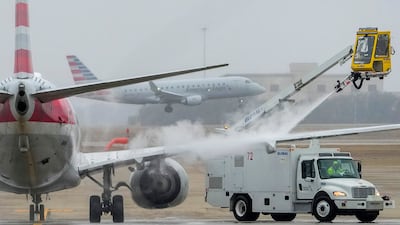 Ice is blasted from an American Airlines plane at Dallas/Fort Worth International Airport in Texas. The Dallas Morning News / AP