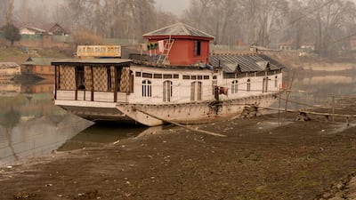 A houseboat in River Jhelum, Srinagar, sits low because of depleted water levels. Wasim Nabi for The National