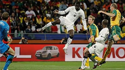 Ghana's Jonathan Mensah, centre, fires the ball towards Mark Schwarzer, left, the Australia goalkeeper, in a 1-1 draw.