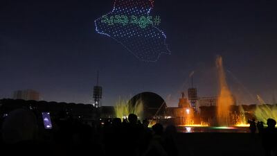 People look at an aerial image projection depicting an Iraqi map during New Year celebration in Baghdad, Iraq, January 1, 2024. Reuters