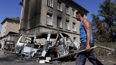 A man walks past vehicles destroyed during the recent shelling in the eastern Ukrainian town of Ilovaysk. The West has not understood Russia's fears of NATO's expansion, writes Tony Karon (REUTERS/Maxim Shemetov)