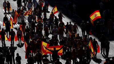 People carry Catalan and Spanish flags as demonstrators gathered for a pro-union demonstration organised by the Catalan Civil Society organisation in Barcelona, Spain. Juan Medina / Reuters