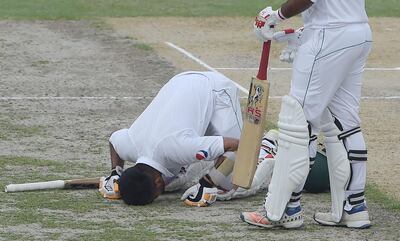 Babar Azam prostrates as he celebrates scoring his first Test century in Dubai on Sunday. AFP