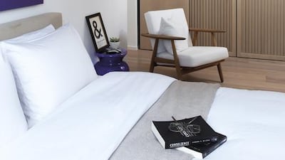 These playful optical tricks continue through to the master bedroom, where built-in wall-to-wall closets finish a couple of inches below the ceiling. This changes the perspective from the bed: the couple can look up at a backlit wall, rather than staring at a row of cabinets.