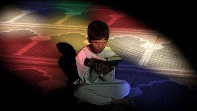 A Palestinian boy reads the Quran in the Al-Omari mosque during the Muslim holy month of Ramadan, in Gaza City, June 20, 2015. Most Muslims around the world have begun observing the holy fasting month of Ramadan. Mohammed Saber / EPA