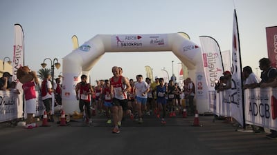 Abu Dhabi residents take part in a run to raise awareness of breast cancer. (Lee Hoagland / The National)