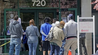 People queue outside the Utah Department of workforce Services, in Salt Lake City. The markets should have been cautious about reading too much into May’s more encouraging US employment figures. Associated Press