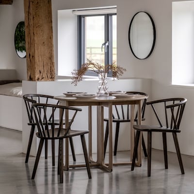 Create the impression of space with a folding dining table and mirrors to help light bounce around the room. Photo: Sweetpea & Willow