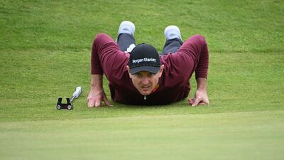 England's Justin Rose lines up his putt on the 14th green. AFP