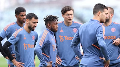 Manchester United players Bruno Fernandes, left, and Fred, centre, listen to the coaches during a training session in Pert. AFP