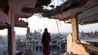Hidya Atash, stands on the top floor of her home as overlooking the destruction in Shujayea at dawn on August 8, 2014. The UN Comission of Inquiry found that Israel employed ‘huge firepower’ during the summer war on Gaza last year which killed more than 2,100 Palestinians. Photo by Heidi Levine for The National