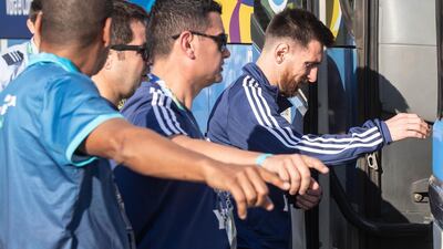 Lionel Messi and teammates board a bus before training. EPA