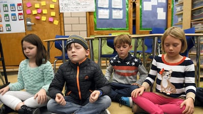 DENVER, CO - November 17: Merrill Middle School second graders from left to right, Piper Slavin, Peter Nichols, Carter Barker and Lila Gerlach close their eyes and collect their thoughts during a 15-minute Creative Challenge Community Mindfulness class at Merrill Middle School November 17, 2016. (Photo by Andy Cross/The Denver Post via Getty Images)
