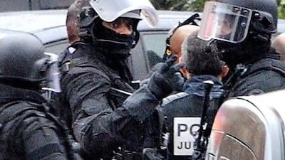 Members of the RAID special police forces unit prepare to enter the apartment block where Mohamed Merah, the man suspected of a series of deadly shootings, was holed up today.
