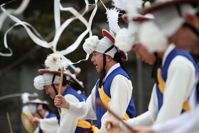 South Korean performers wearing traditional clothes participate in a traditional game during Lunar New Year holidays at Gyeongbokgung Palace. Getty Images