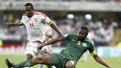 UAE's Ahmed Khalil, left, and Osama Hawsawi of Saudi Arabia in action at Hazza bin Zayed Stadium on Tuesday. Chris Whiteoak / The National
