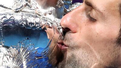 Novak Djokovic kisses his trophy. Reuters