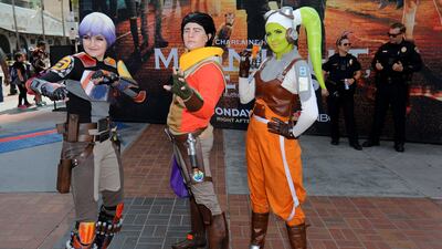 Costumed attendees pose for pictures as police officers look on at Comic Con International. Mike Blake / Reuters