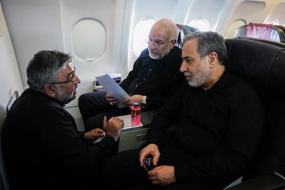 Mohammad Bagher Ghalibaf, centre, and Abbas Araghchi, right, on their way to the talks. AFP