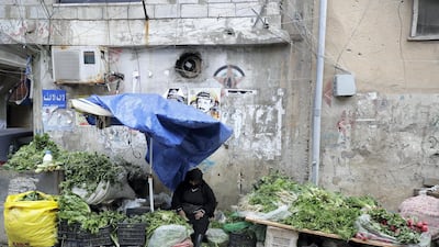 A Palestinian woman sells vegetables in Burj Al Barajneh. The UN agency for Palestinian refugees warned it faced its worst funding crisis ever after the White House froze tens of millions of dollars in contributions, a move Palestinian leaders decried as cruel and biased. JOSEPH EID / AFP