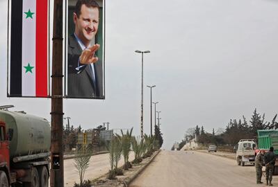 A picture taken during a guided tour organised by the Syrian Ministry of Information shows a poster of Syrian President Bashar Al Assad adorning the M5 highway connecting Aleppo to Damascus on February 18, 2020. Louai Beshara / AFP