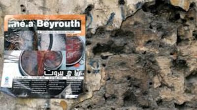 A poster promoting the 2002 Né à Beyrouth Festival of Lebanese Film is plastered on a bullet-riddled wall on the former Green Line in Beirut.