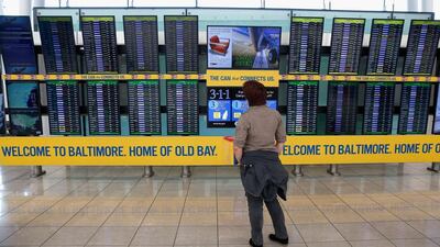 A traveller looks at the board of delayed and cancelled flights in the Southwest Airlines terminal at Baltimore/Washington International Thurgood Marshall Airport. Hundreds of flights in the US northwest were grounded by a 'technical glitch'. Rob Carr / Getty Images / AFP
