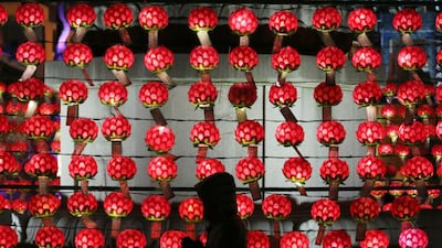 A woman prays in front of lanterns to welcome in the upcoming New Year at the Jogyesa Buddhist temple in Seoul, South Korea. AP Photo