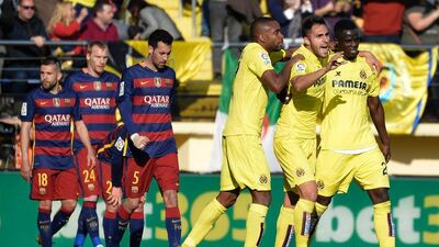 Villarreal players, right, celebrate their second goal during their Primera Liga match against Barcelona at El Madrigal stadium in Vila-real on March 20, 2016. / AFP / JOSE JORDAN