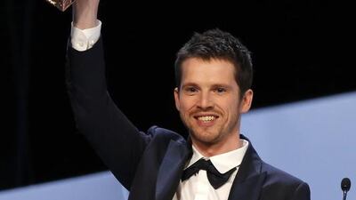 French actor Pierre Deladonchamps holds up his Most Promising Actor award. Etienne Laurent / EPA