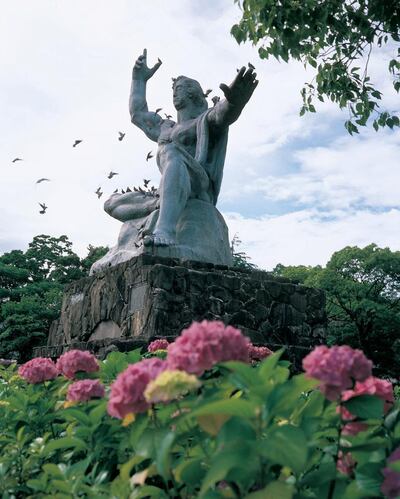 Peace Statue surrounded by the city flower hydrangea. Courtesy Nagasaki Prefecture Convention and Tourism Association