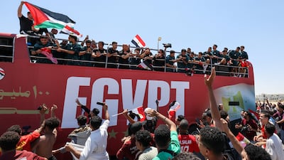 Egypt's national football team ride on a bus as they are welcomed by fans at El Alamein International Airport on their return from the 2026 FIFA World Cup. Reuters