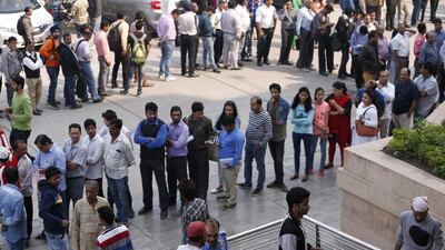 A security guard uses indelible ink to mark the fingers of people entering to exchange discontinued currency outside an Axis Bank branch in central New Delhi, India, Wednesday, Nov. 16, 2016 as lines form outside the bank, with people desperate for cash amid a chaotic government effort to crack down on corruption by banning high-denomination currency notes. Saurabh Das/AP Photo