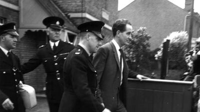 Great Train Robber Ronnie Biggs, pictured being escorted by three police officers in 1963, has died aged 84. Evening Standard via Getty Images