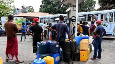 People queue to buy diesel at a fuel station in the Sri Colombo. AFP