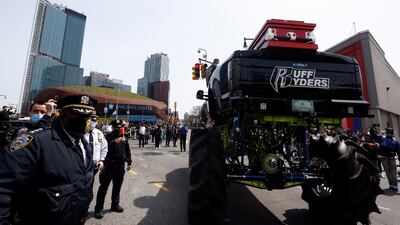 Members of the NYPD stand next to the monster truck holding the casket of US rapper DMX. EPA