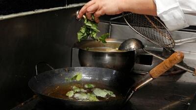 6. Add the basil leaves to the oil in which you fried the fish and remove them after about 20 seconds.
