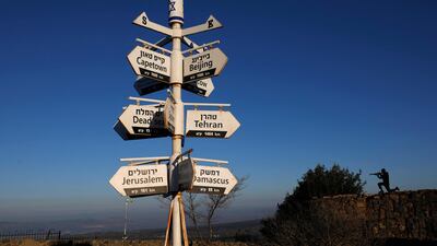 A metal cutout of an Israeli soldier stands behind signs pointing out distances to different cities at an army post on Mount Bentalin in the Israeli-annexed Golan Heights. AFP
