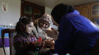 Syrian refugee Aya Al Souqi, 6, has her hearing tested by Zaineb Abdulla, right, vice president of the Chicago-based charity Deaf Planet Soul, in Joub Jannine village in Lebanon’s Bekaa valley on March 12, 2017. Hassan Ammar / AP Photo