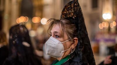 A woman wearing traditional 'mantillas' attend a mass at Collegiate church of San Isidore in downtown Madrid, Spain. For a second year running, Spain has had to cancel Easter Week processions to help stop the spread of COVID-19. AP Photo