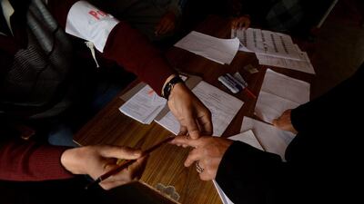 A Kashmiri Muslim voter has her finger marked with ink before casting her ballot at a polling station at Bijbehara some 42 kms south of Srinagar. Tauseef Mustafa / AFP Photo