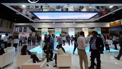 Visitors view the scale models of Nakheel projects at the Cityscape Global 2014. Satish Kumar / The National