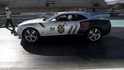 WWE wrestler Sami Zayn takes a car out onto Yas Marina Circuit's drag strip on Wednesday in Abu Dhabi. Christopher Pike / The National