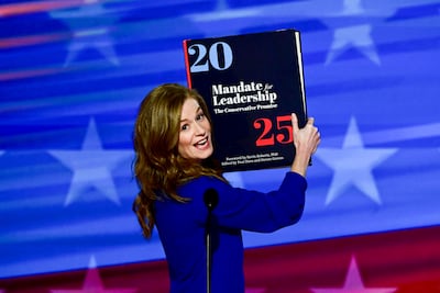 Michigan state Senator Mallory McMorrow holds up a Project 2025 book during the Democratic National Convention. Bloomberg