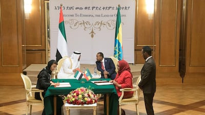 Sheikh Mohamed bin Zayed and Abiy Ahmed witness a signing ceremony. Seated is Noura Al Kaabi, UAE Minister of Culture and Knowledge Development. Mohamed Al Hammadi / Crown Prince Court - Abu Dhabi
