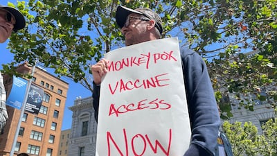A man holds a sign urging increased access to the monkeypox vaccine during a protest in San Francisco, California. AP